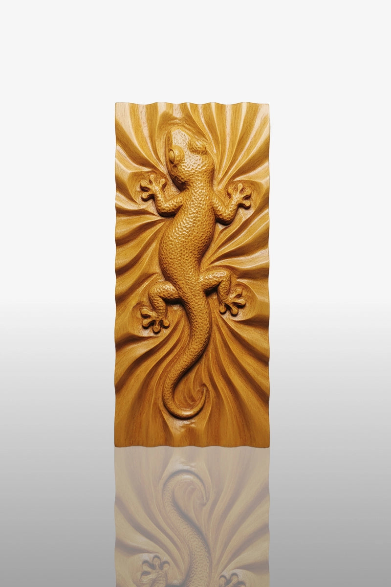 Hand-carved gecko relief in camphor wood with radiating fold background and textured skin