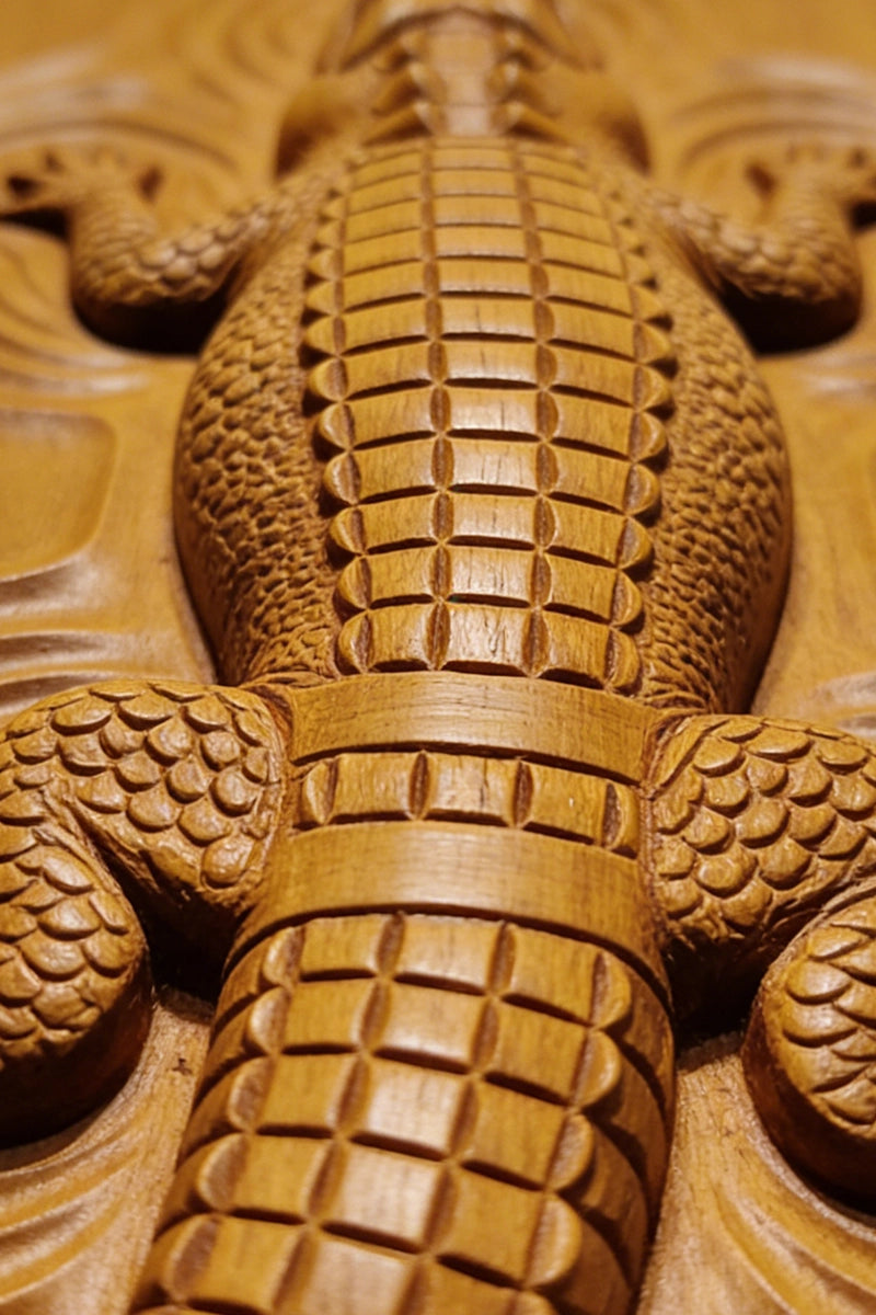 Crocodile wood carving detail showing dorsal scales and claw texture