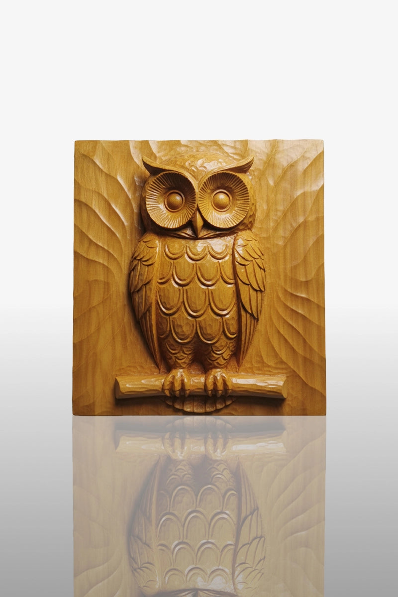 Hand-carved owl relief in camphor wood perched on branch with layered feather detail