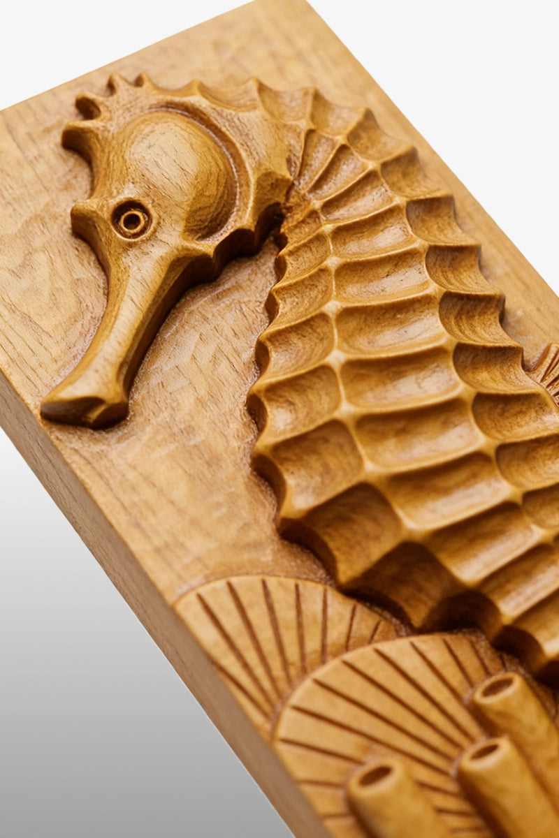 Seahorse wood carving detail showing segmented body plates and coral texture