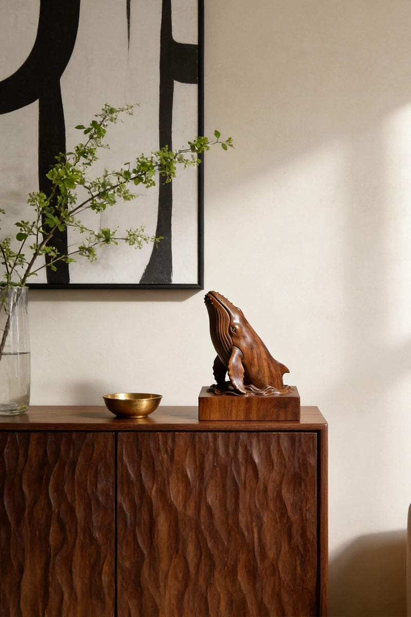 Humpback whale wood sculpture displayed on bookshelf or desk