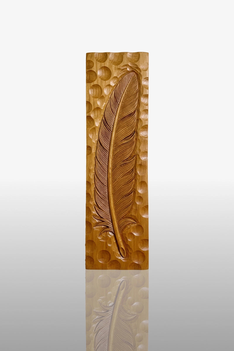 and-carved feather relief in camphor wood with fine barb detail and dimpled background