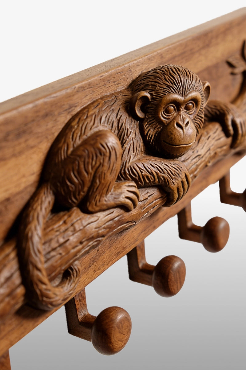Monkey wood carving detail showing fur texture and branch bark